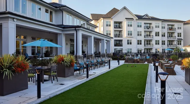 a view of a porch with a table and chairs