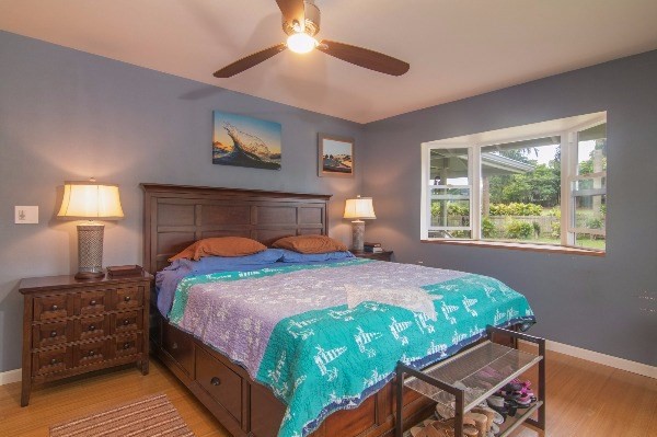 418 Puuopae Road, Unit A Kapaa, HI 96746 - Photo 17 of 25 a bedroom with a bed and a lamp on dresser