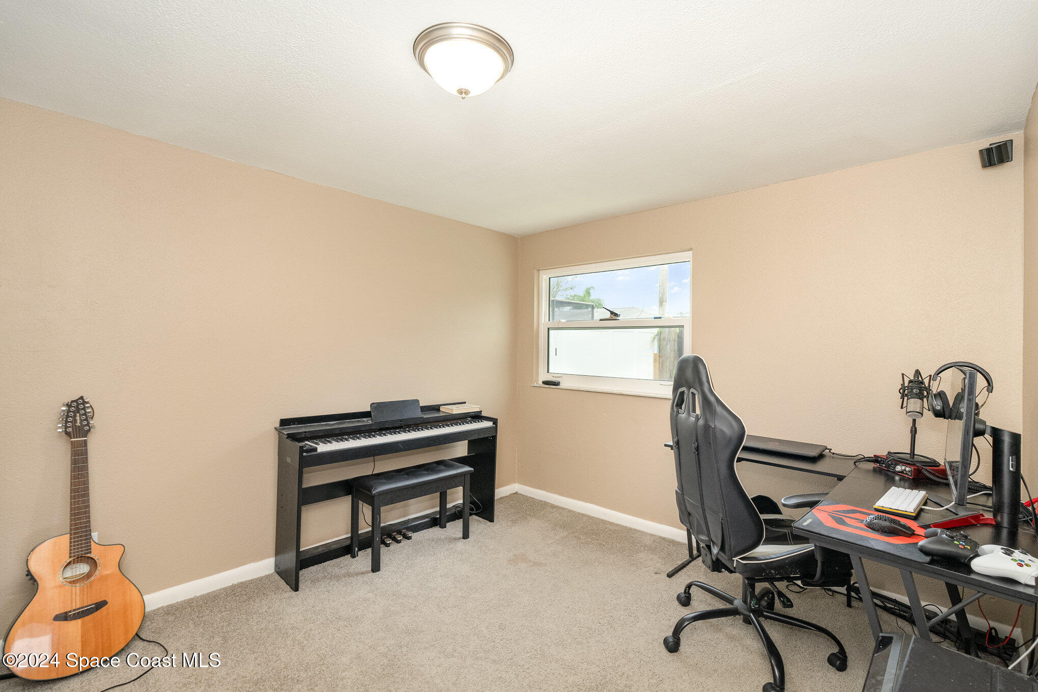 800 1st Street Merritt Island, FL 32953 - Photo 12 of 28 a view of a workspace with furniture and a window