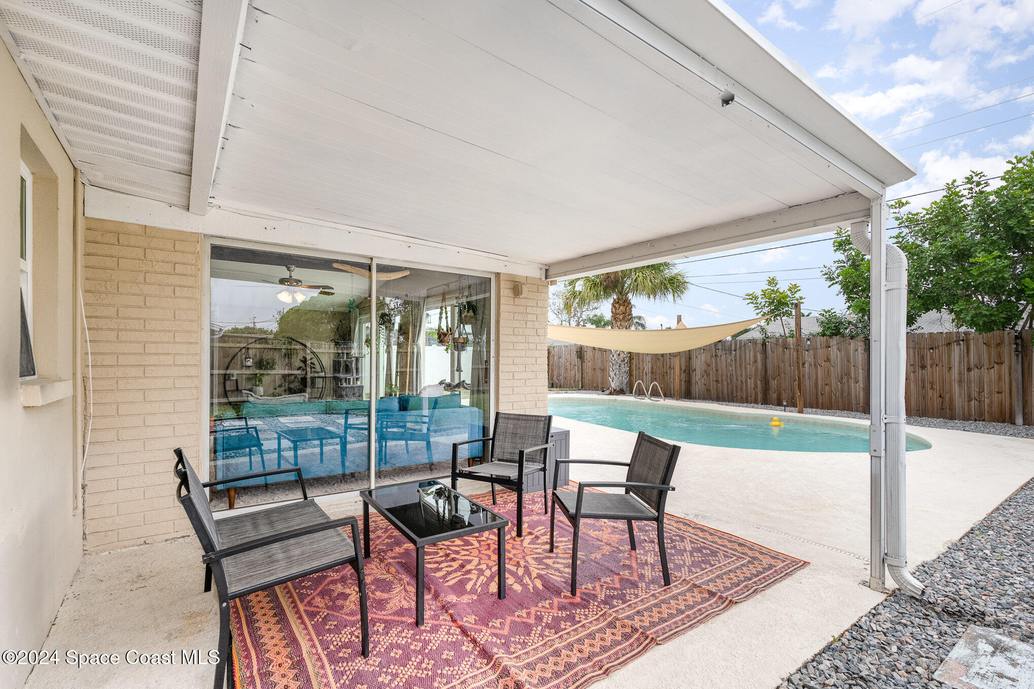 800 1st Street Merritt Island, FL 32953 - Photo 14 of 28 a view of a patio with a dining table and chairs