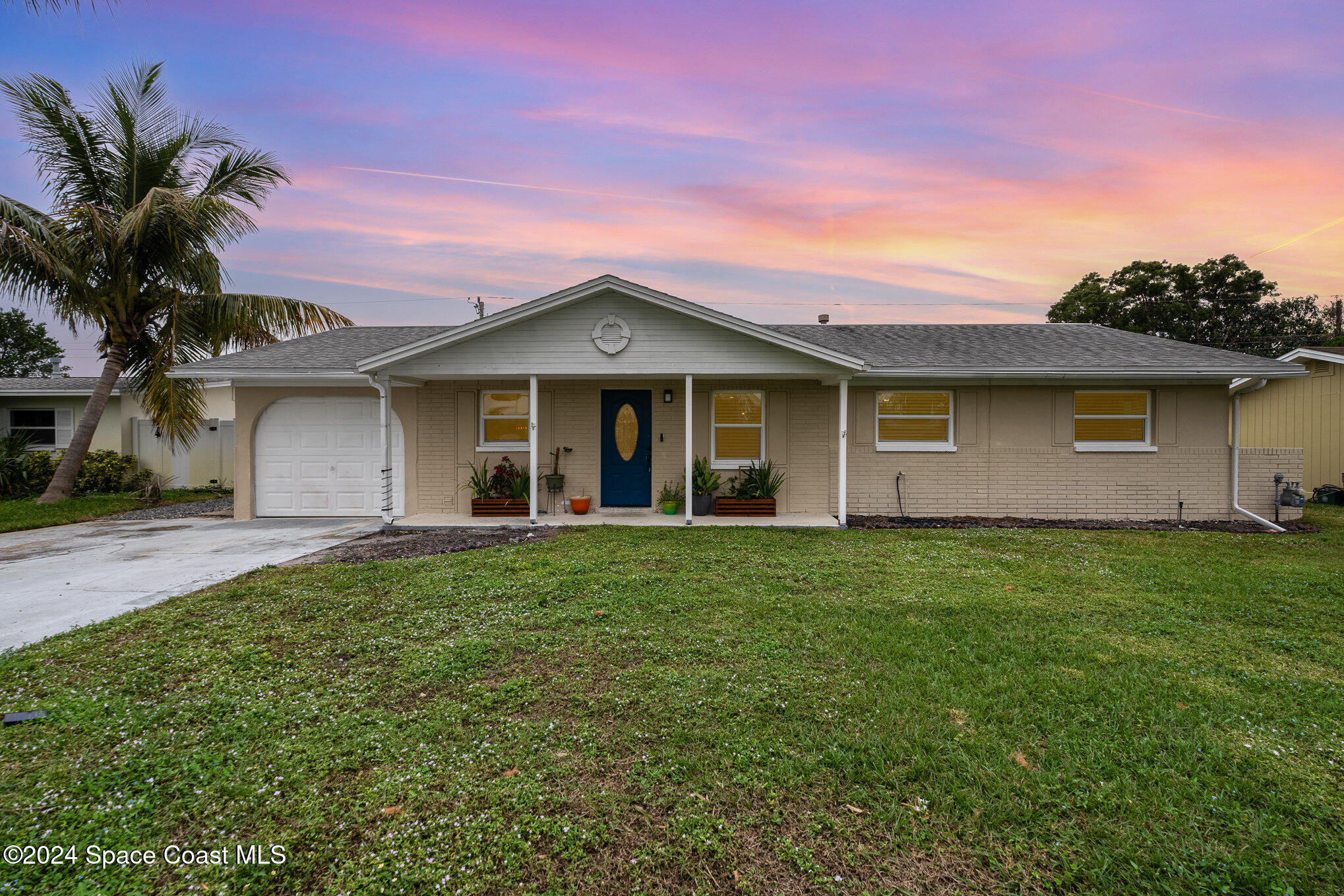 800 1st Street Merritt Island, FL 32953 - Photo 16 of 28 a front view of a house with a garden