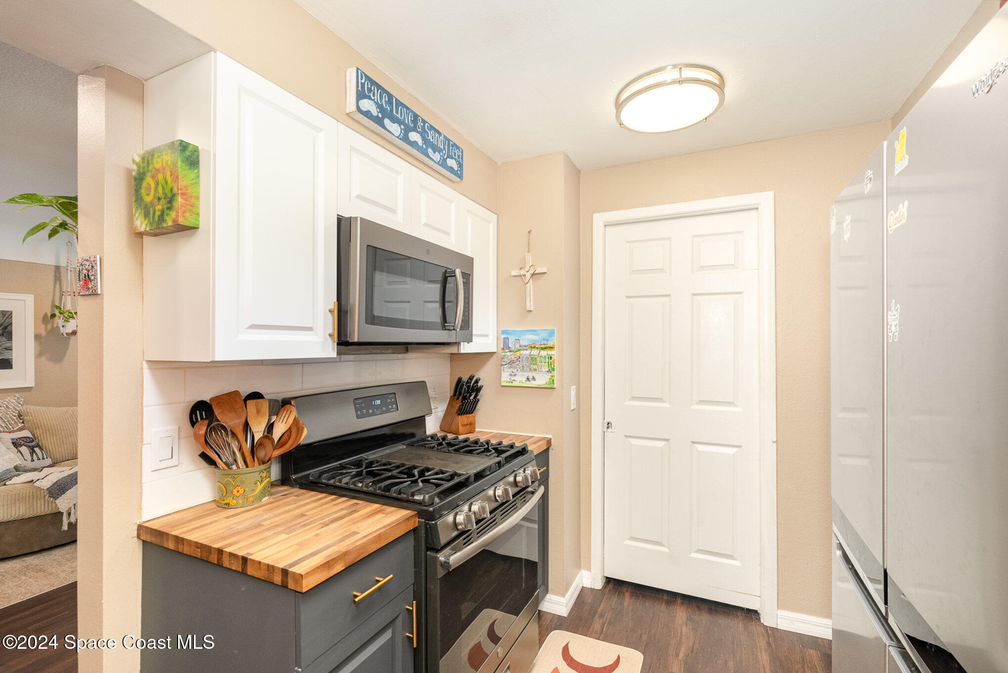 800 1st Street Merritt Island, FL 32953 - Photo 2 of 28 a kitchen with a stove and a microwave