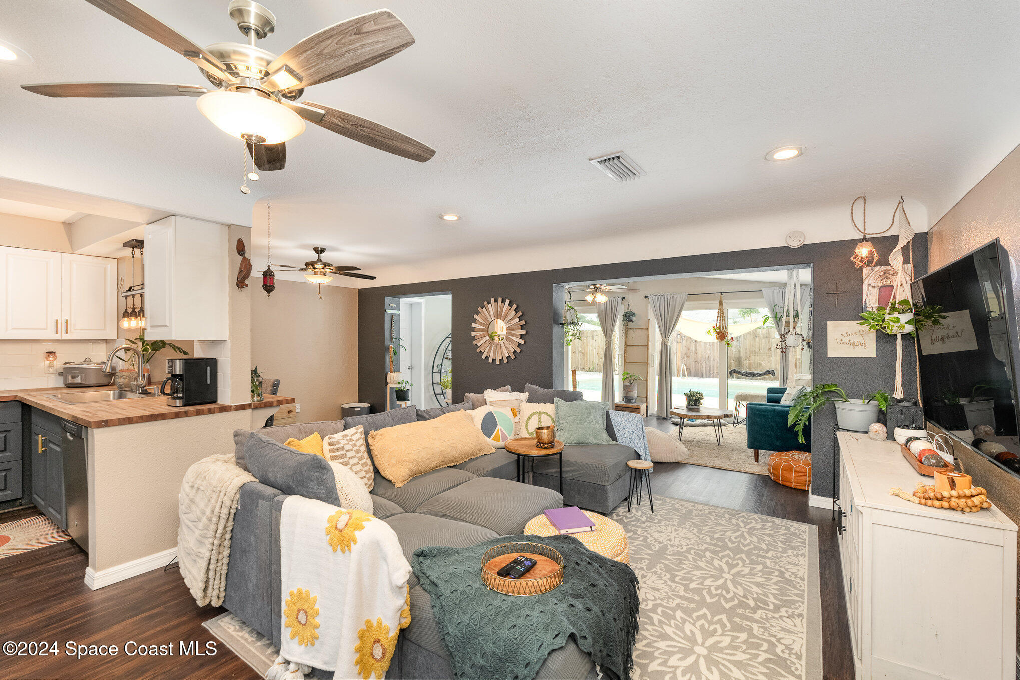 800 1st Street Merritt Island, FL 32953 - Photo 21 of 28 a living room with furniture and a flat screen tv