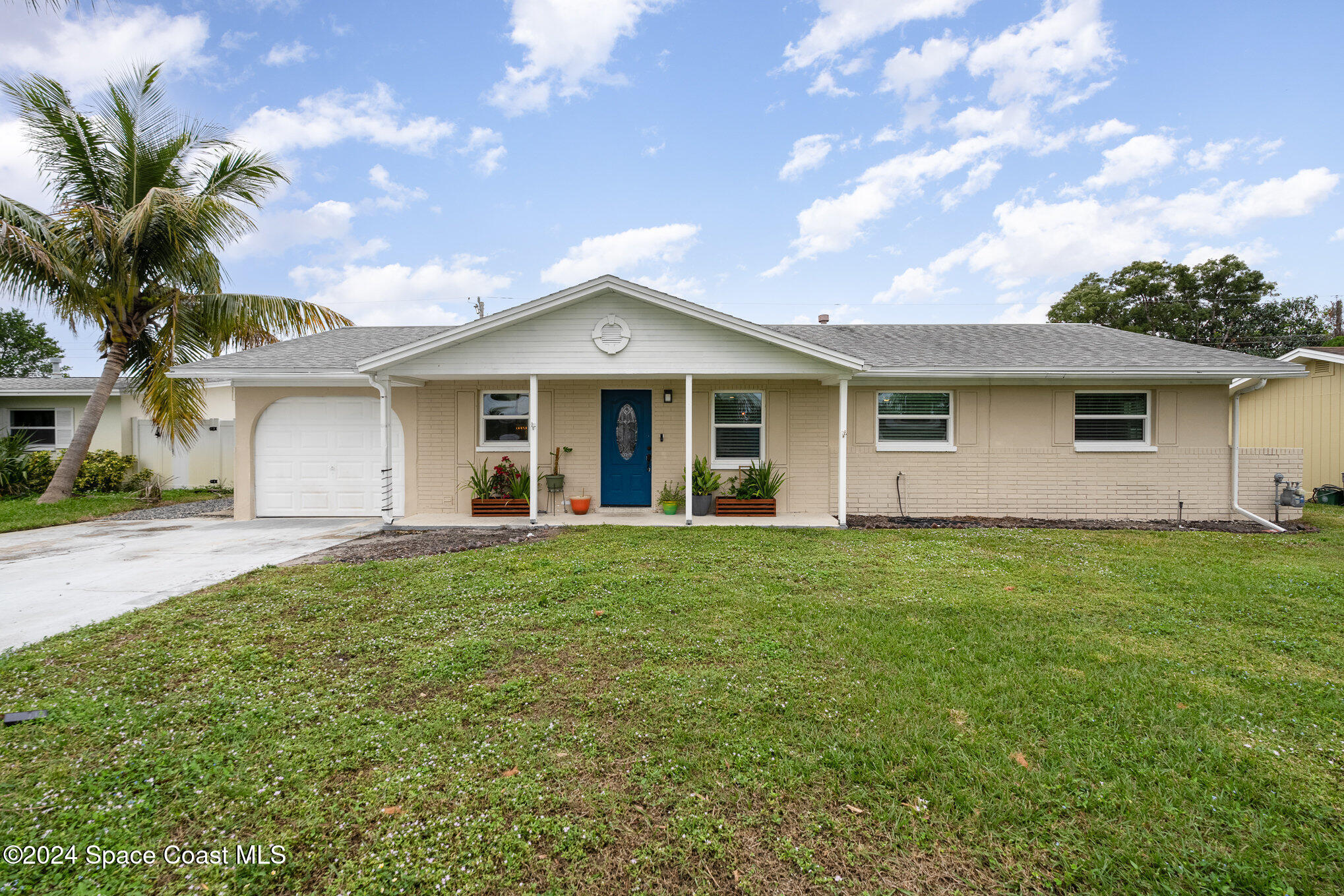 800 1st Street Merritt Island, FL 32953 - Photo 22 of 28 a front view of a house with a garden