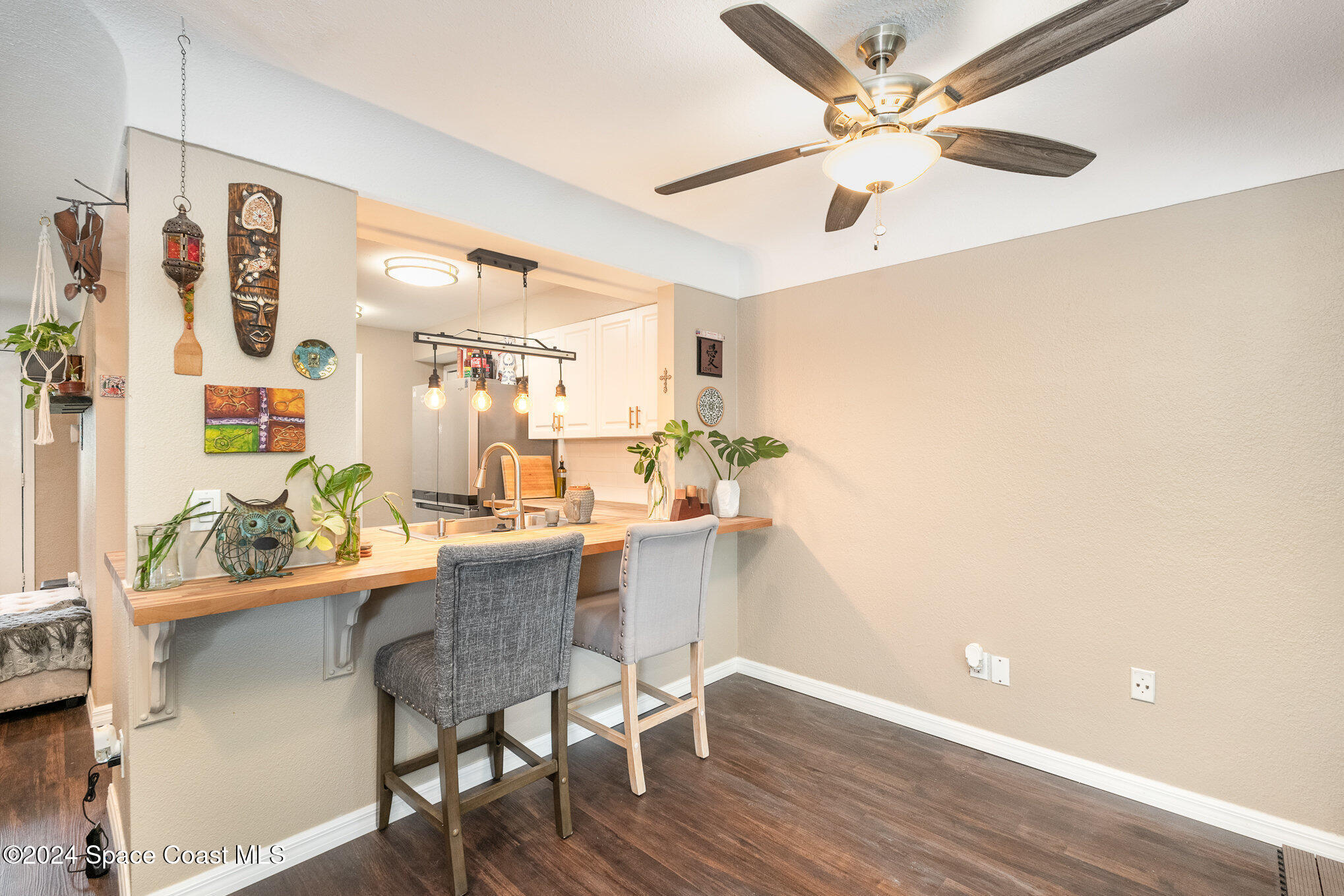 800 1st Street Merritt Island, FL 32953 - Photo 3 of 28 a dining room with furniture and a chandelier fan