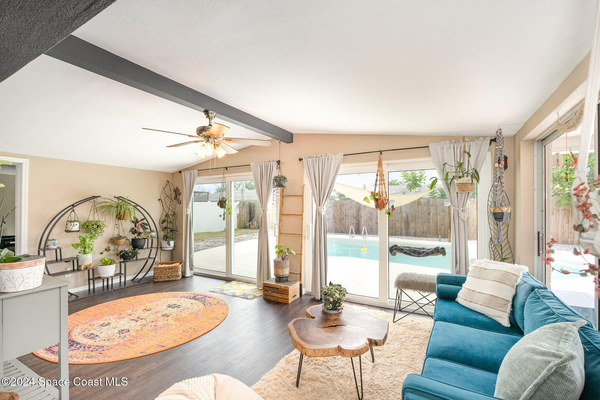 800 1st Street Merritt Island, FL 32953 - Photo 4 of 28 a living room with furniture a large window and a dining table