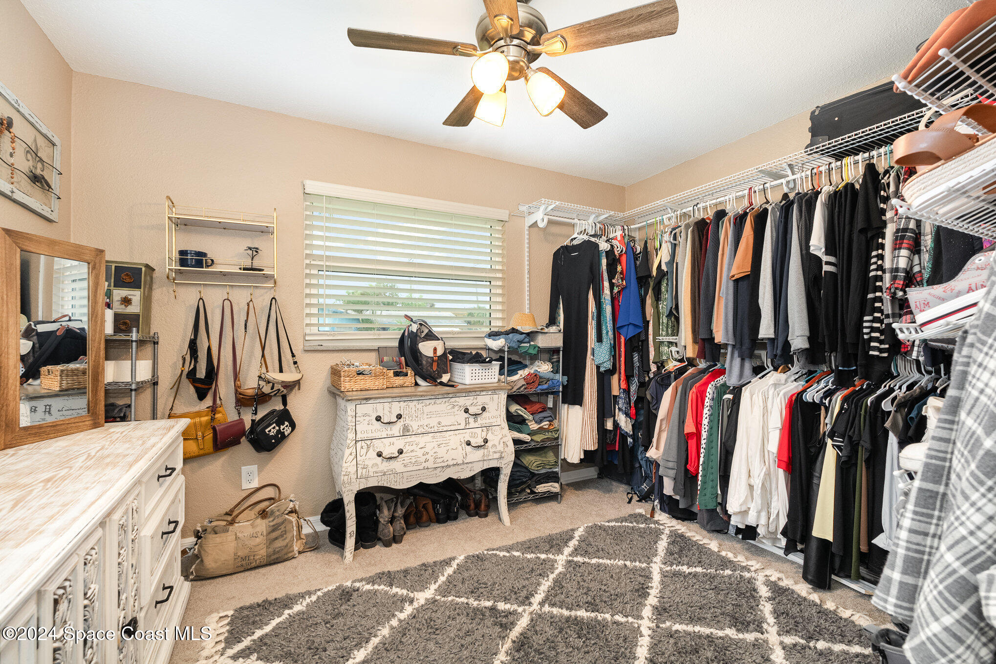 800 1st Street Merritt Island, FL 32953 - Photo 9 of 28 a view of walk in closet with clothes and shoes