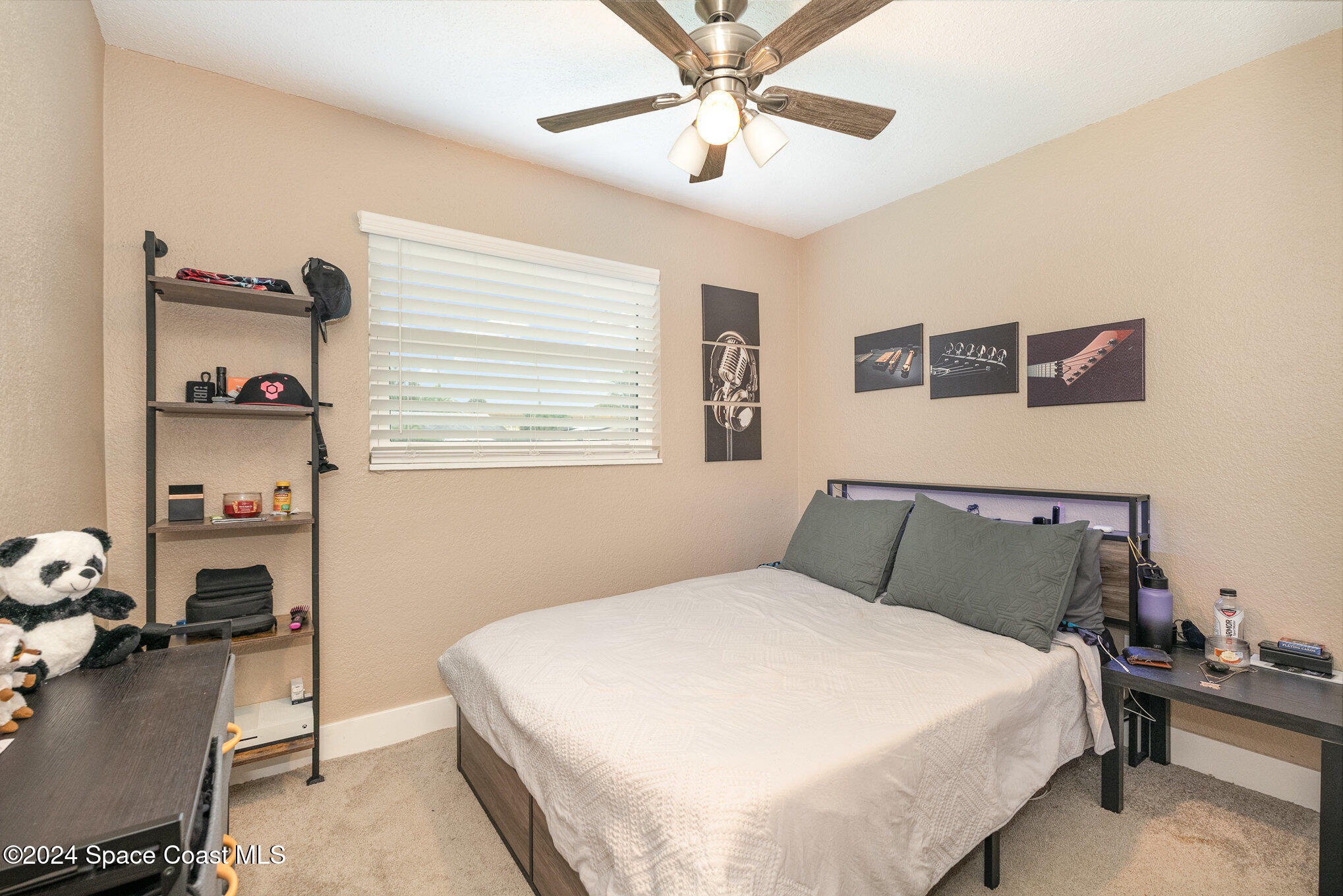 800 1st Street Merritt Island, FL 32953 - Photo 10 of 28 a bedroom with a bed and a chandelier