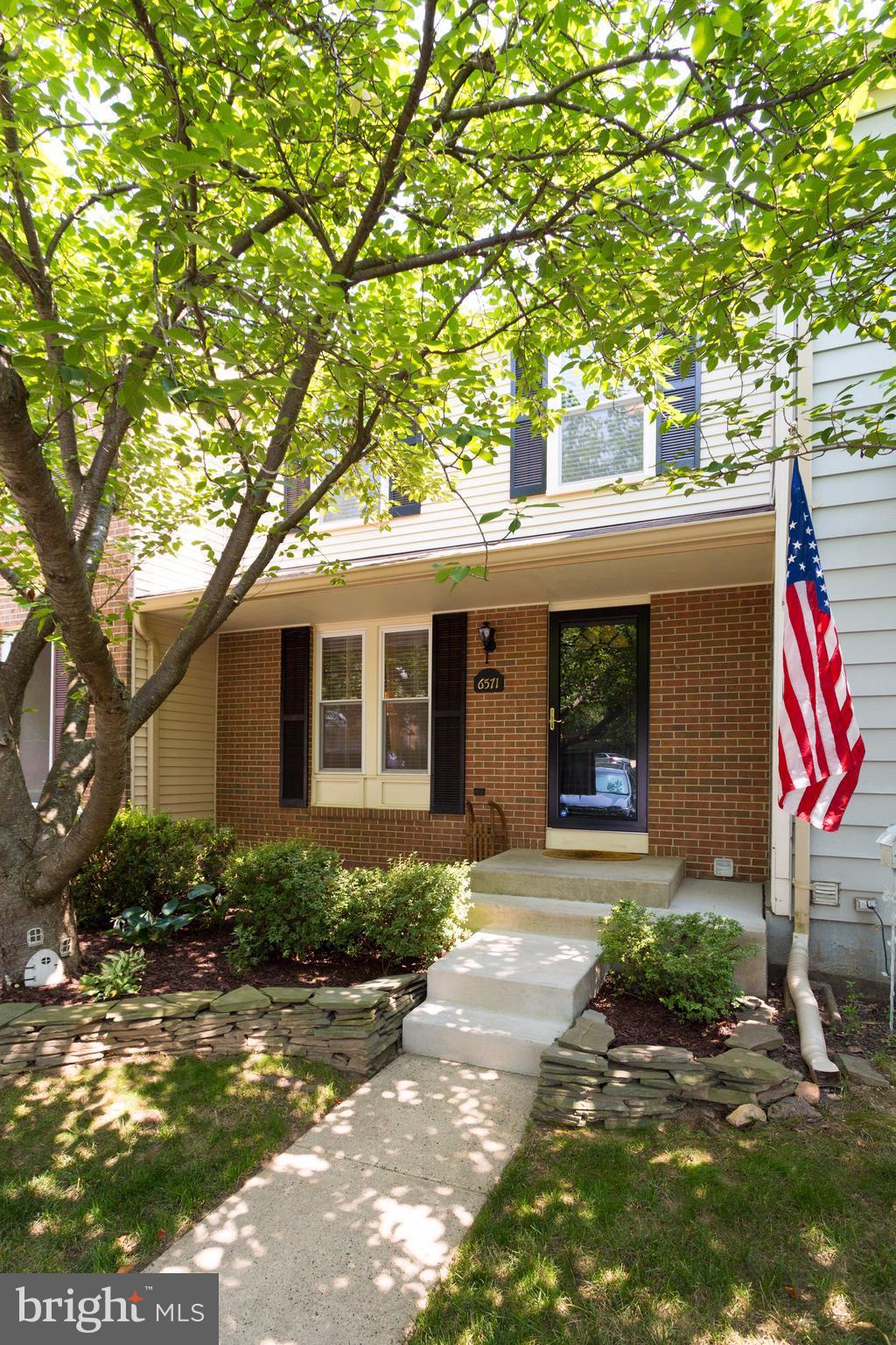 6571 Forest Dew Court Springfield, VA 22152 - Photo 1 of 20 a front view of a house with garden