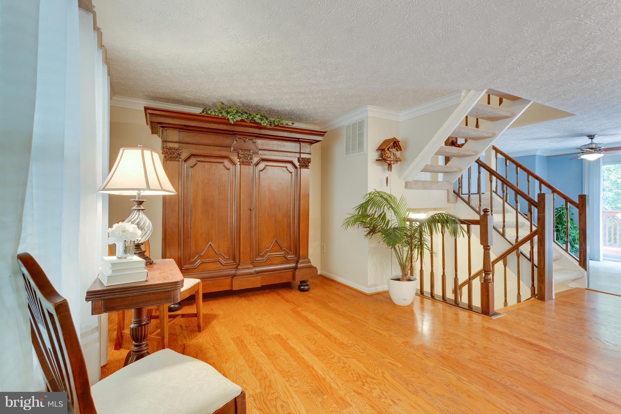 6571 Forest Dew Court Springfield, VA 22152 - Photo 2 of 20 wooden floor with table and windows