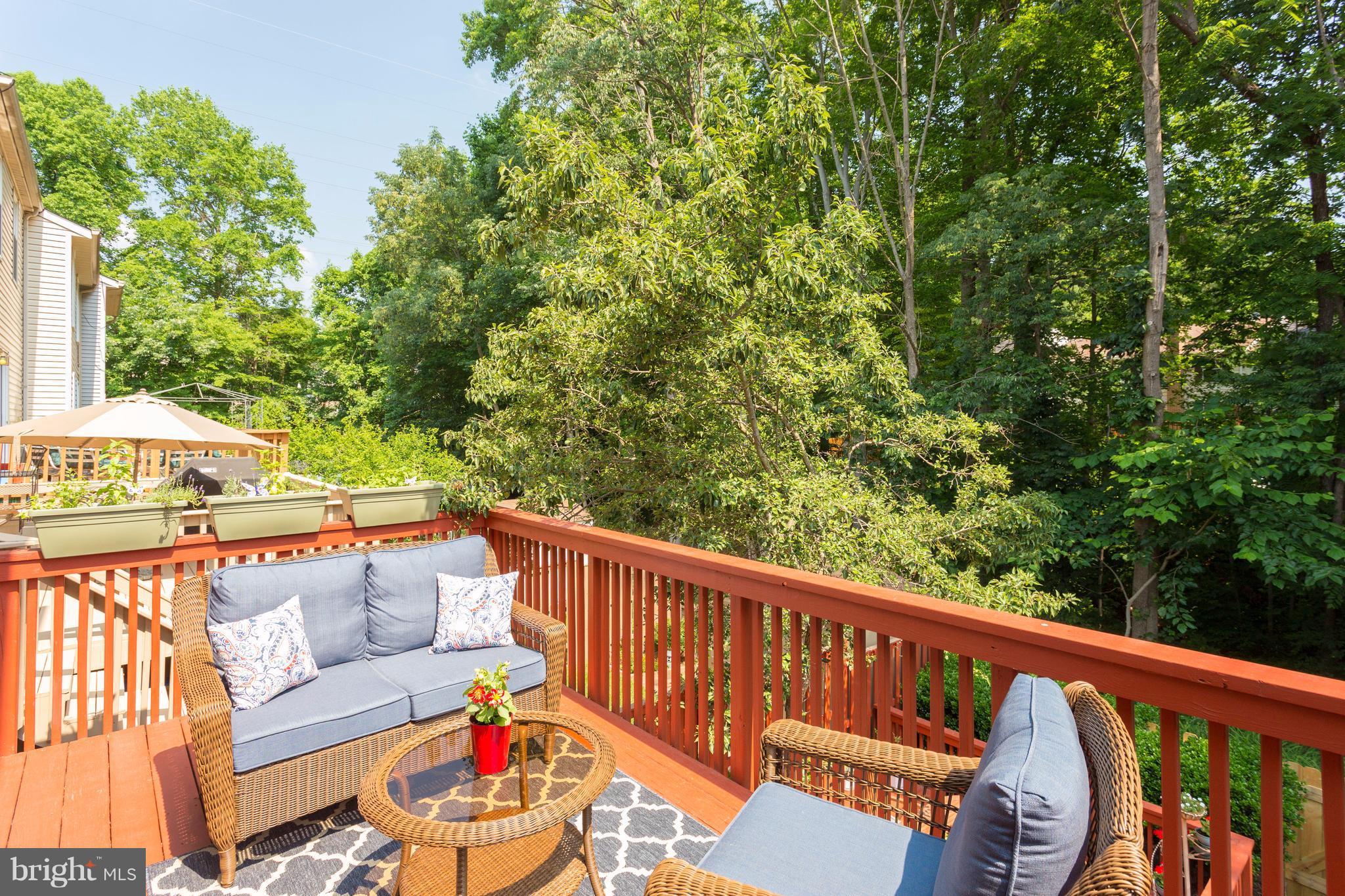 6571 Forest Dew Court Springfield, VA 22152 - Photo 16 of 20 a balcony with wooden floor and outdoor seating