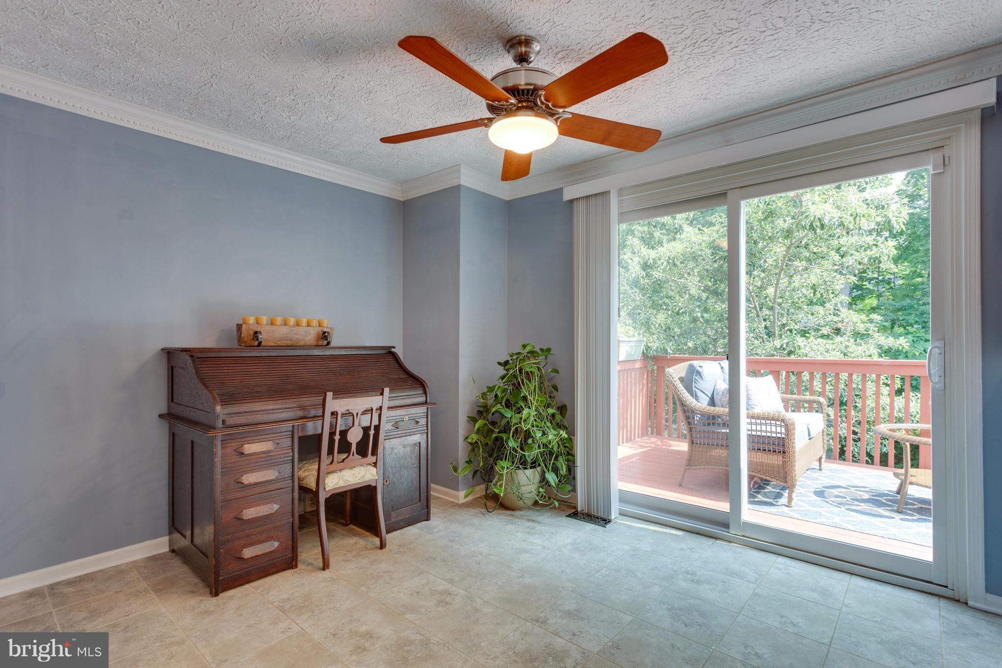 6571 Forest Dew Court Springfield, VA 22152 - Photo 5 of 20 a view of a livingroom with a ceiling fan and a window