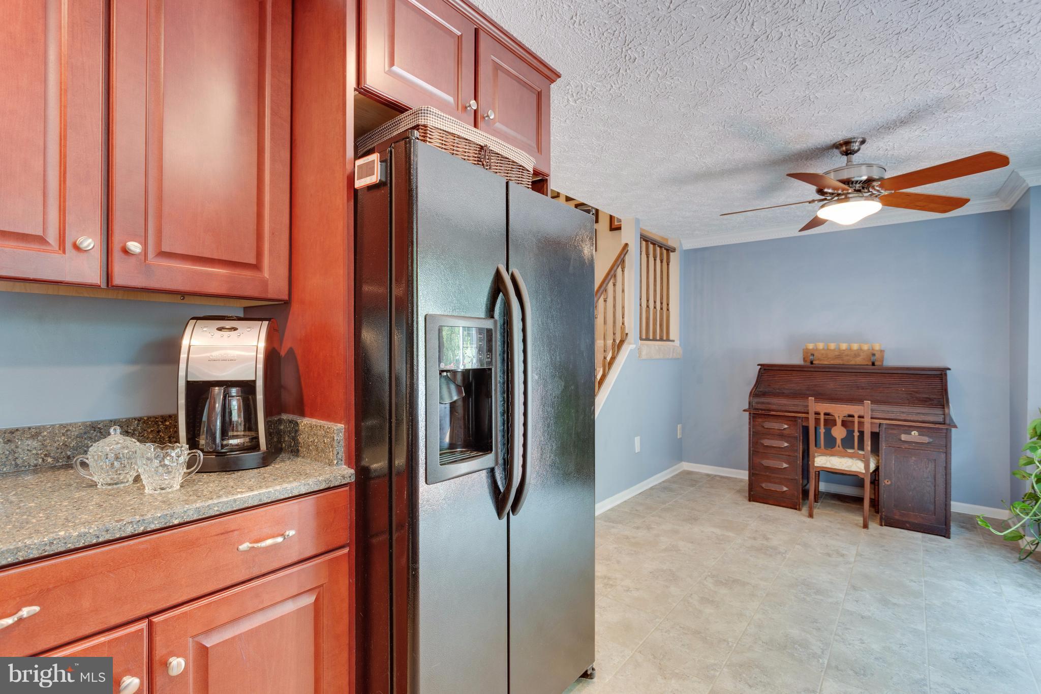 6571 Forest Dew Court Springfield, VA 22152 - Photo 9 of 20 a kitchen with stainless steel appliances granite countertop a refrigerator and a stove