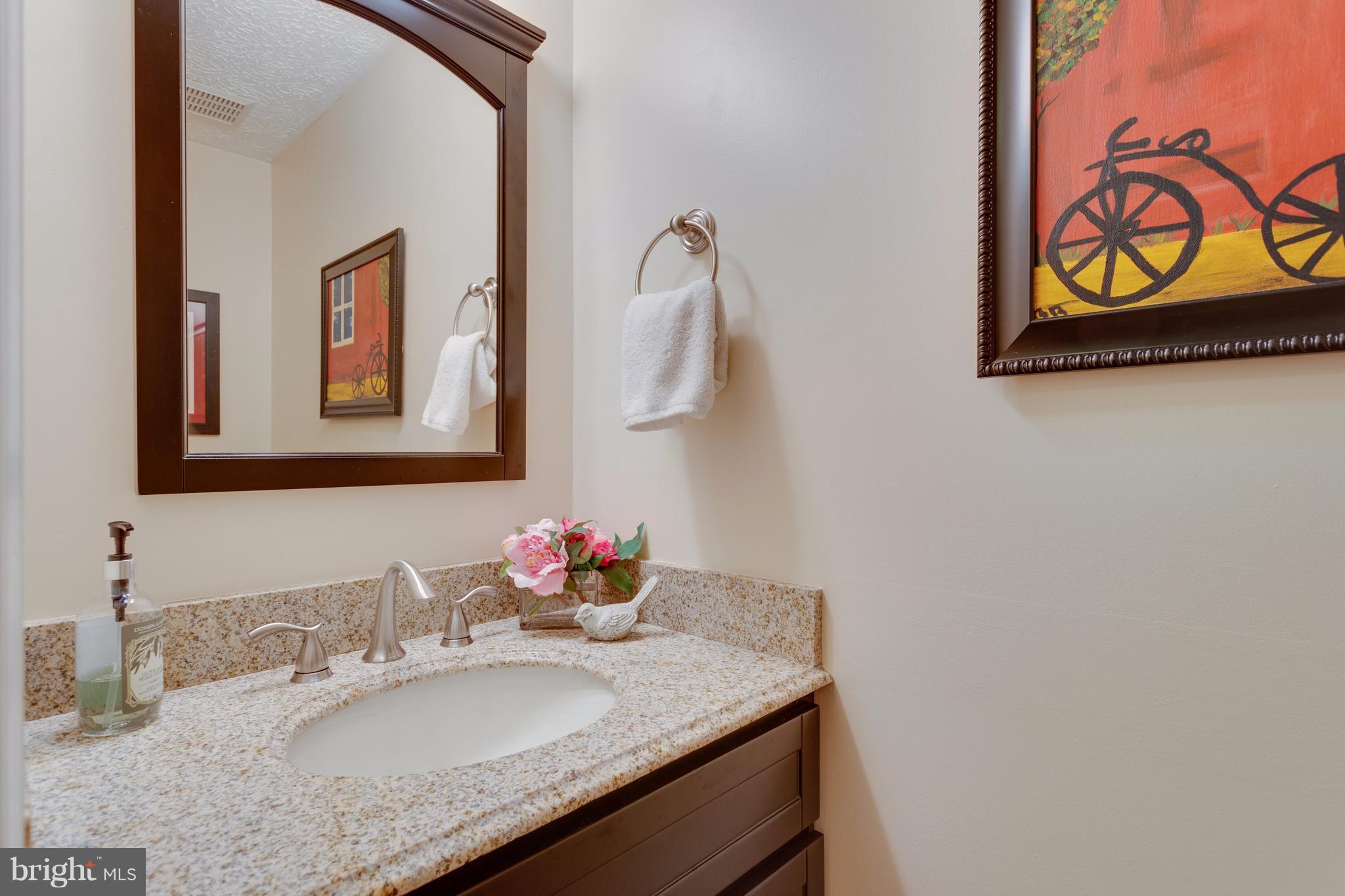 6571 Forest Dew Court Springfield, VA 22152 - Photo 10 of 20 a bathroom with a granite countertop sink and a mirror