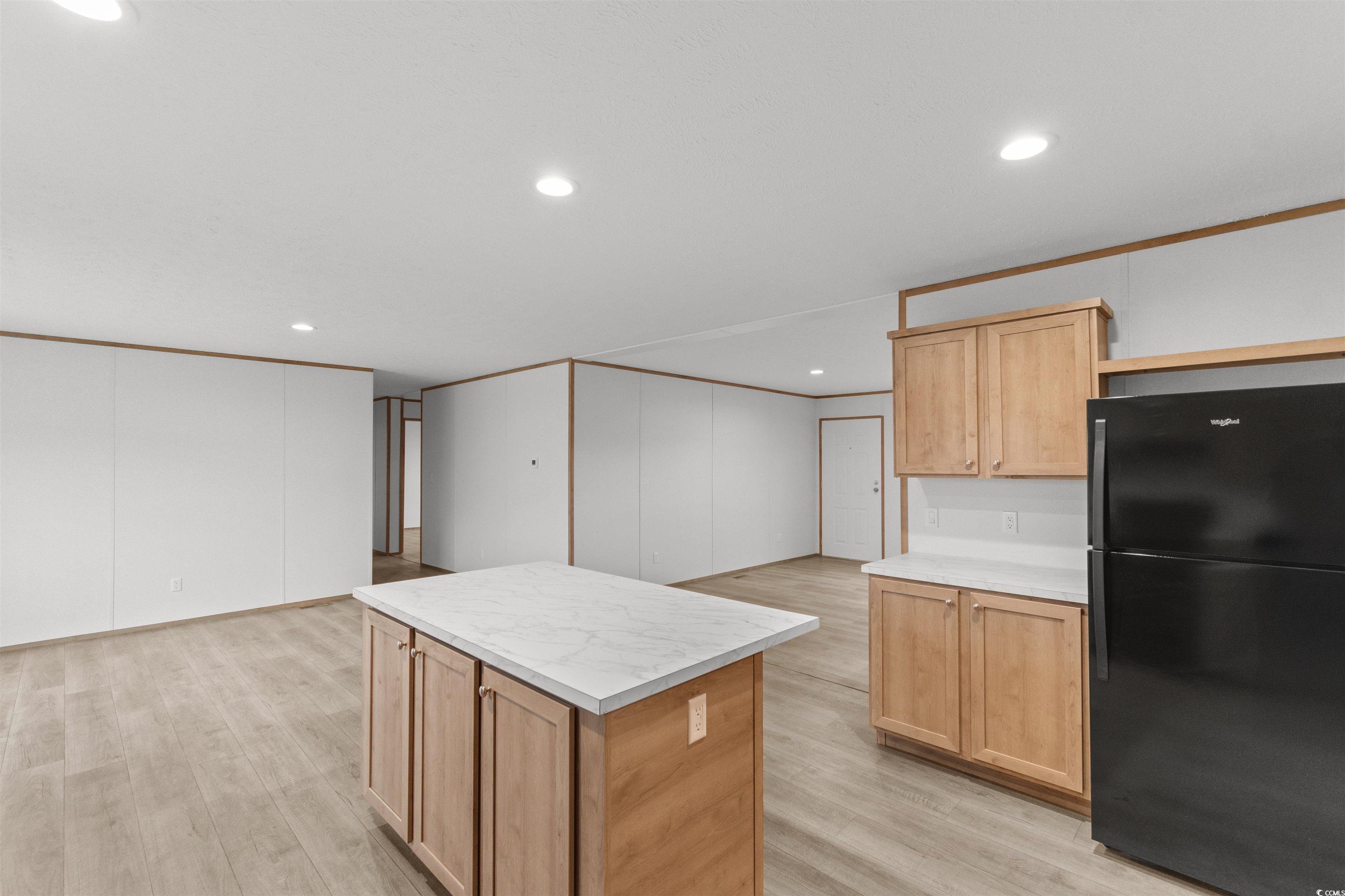 6613 Strickland Road Green Sea, SC 29545 - Photo 10 of 38 Kitchen featuring freestanding refrigerator, light countertops, light wood-style floors, light brown cabinets, and recessed lighting