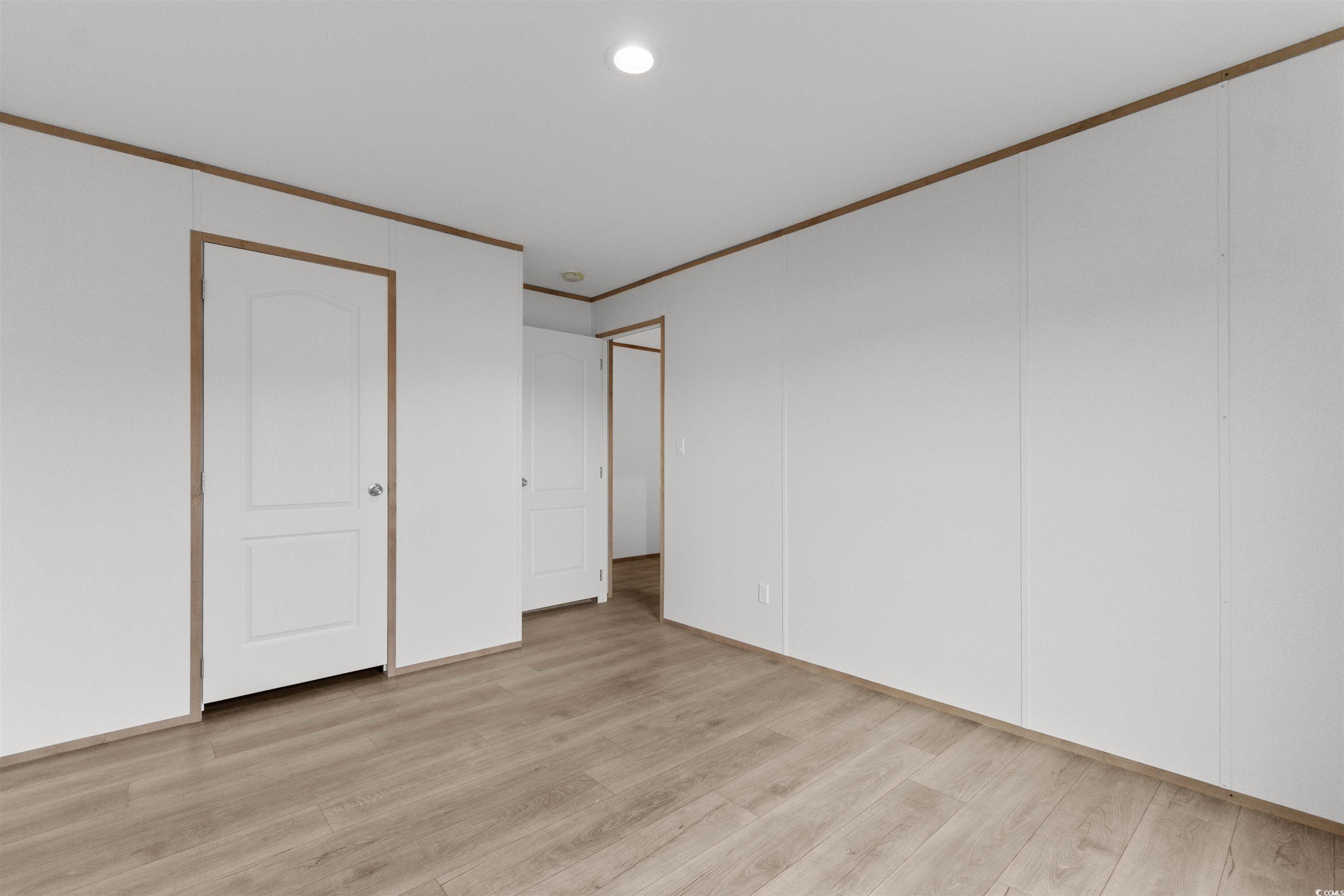 6613 Strickland Road Green Sea, SC 29545 - Photo 12 of 38 Unfurnished bedroom featuring crown molding, light wood-style flooring, a closet, and recessed lighting