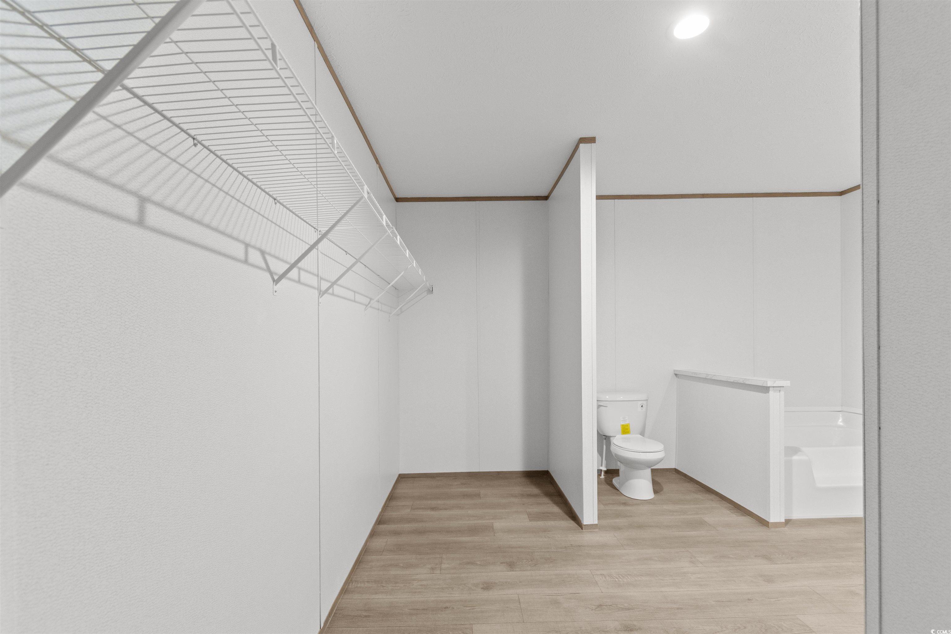 6613 Strickland Road Green Sea, SC 29545 - Photo 14 of 38 Walk in closet featuring light wood-type flooring