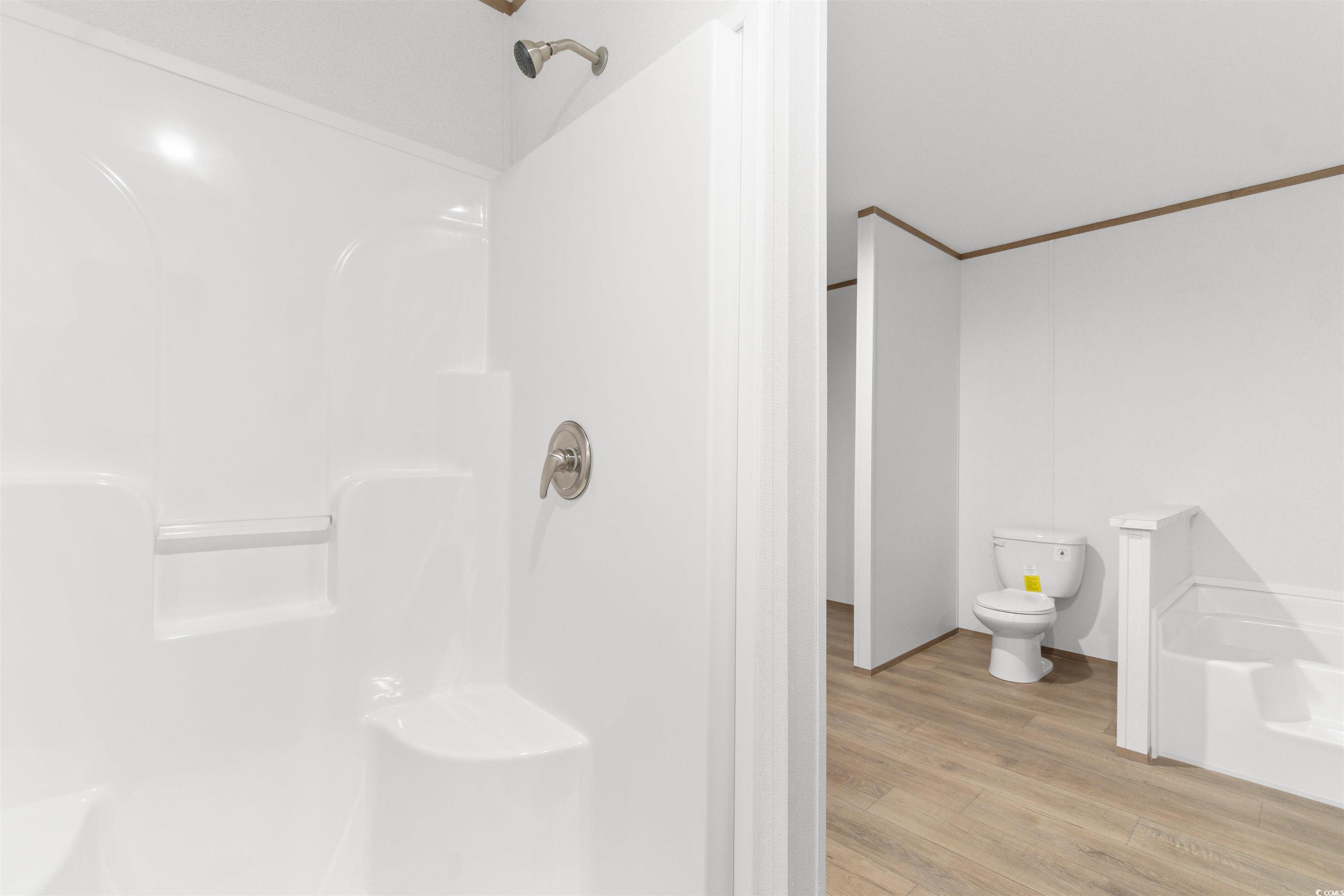 6613 Strickland Road Green Sea, SC 29545 - Photo 16 of 38 Full bathroom with light wood finished floors and a walk in shower