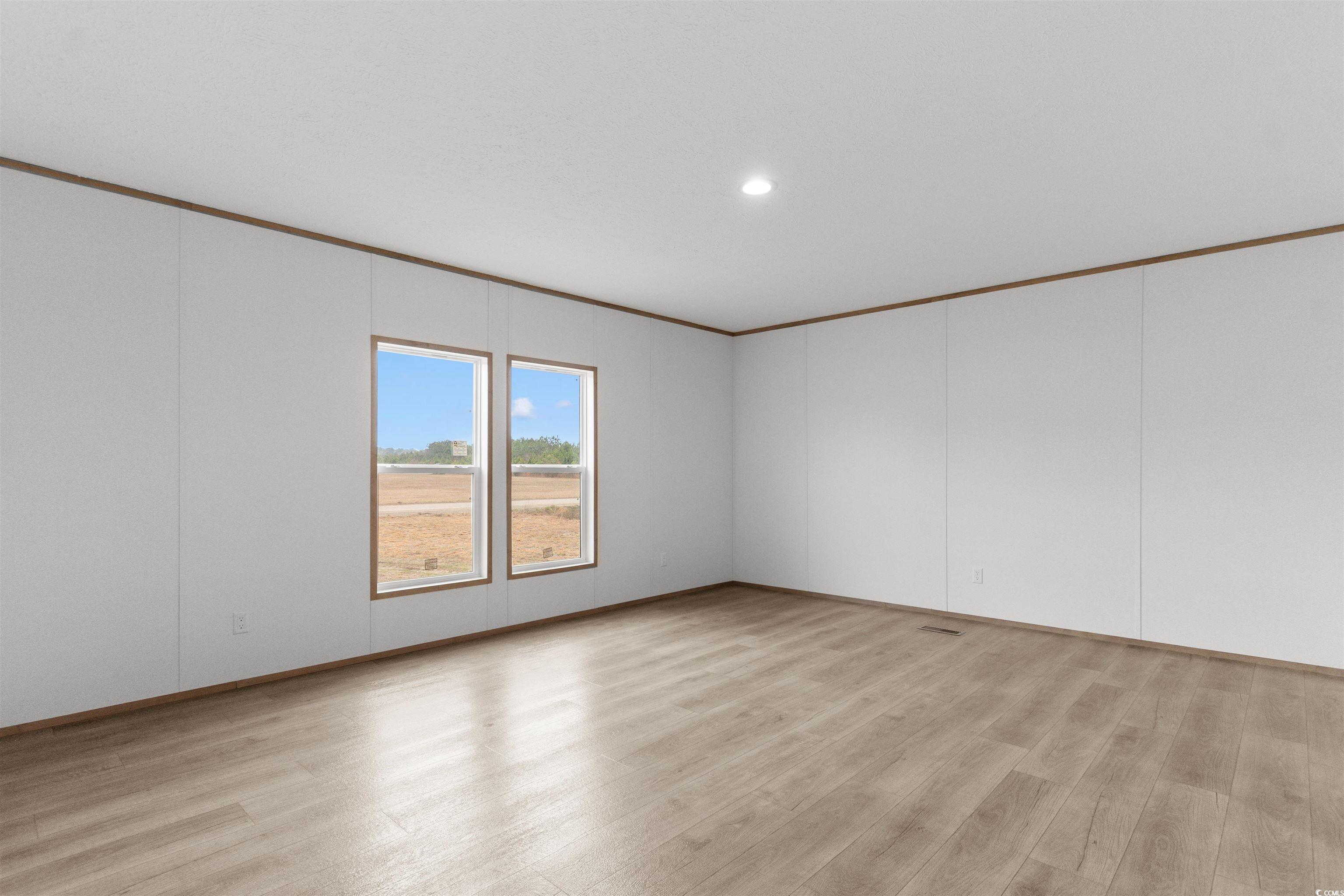 6613 Strickland Road Green Sea, SC 29545 - Photo 17 of 38 Unfurnished room with crown molding, light wood-style flooring, and recessed lighting