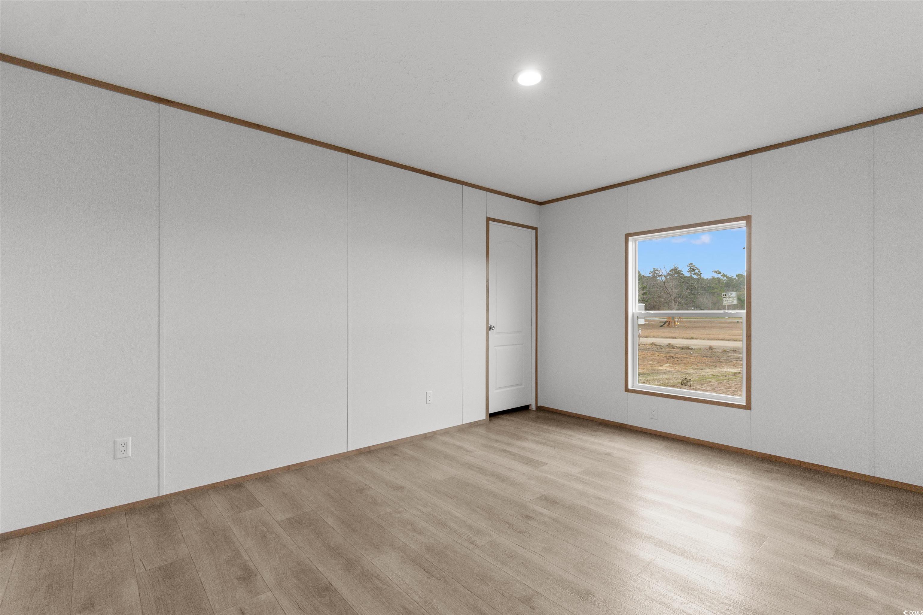 6613 Strickland Road Green Sea, SC 29545 - Photo 21 of 38 Unfurnished room with light wood finished floors, crown molding, and recessed lighting