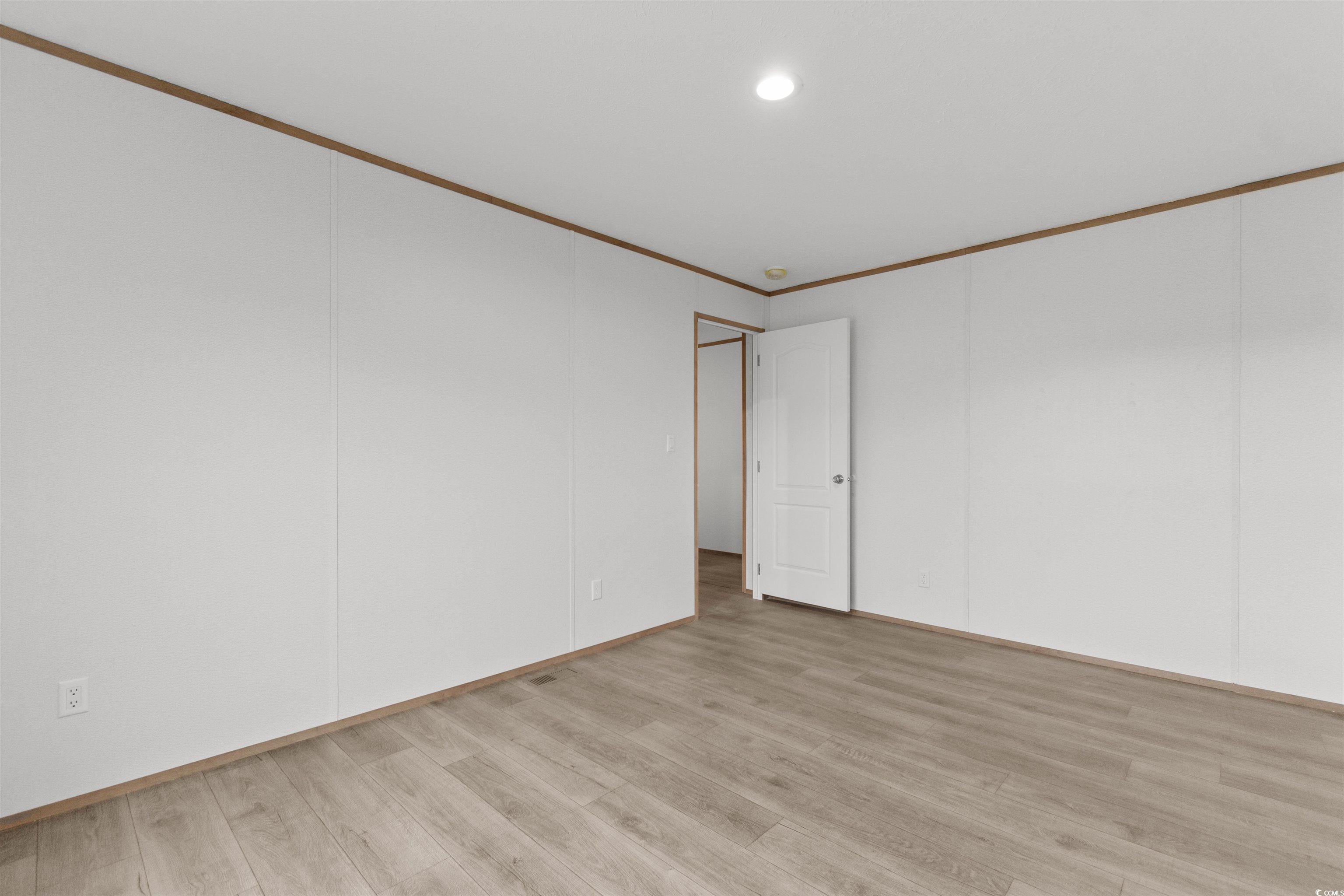 6613 Strickland Road Green Sea, SC 29545 - Photo 22 of 38 Spare room with crown molding, light wood finished floors, and recessed lighting