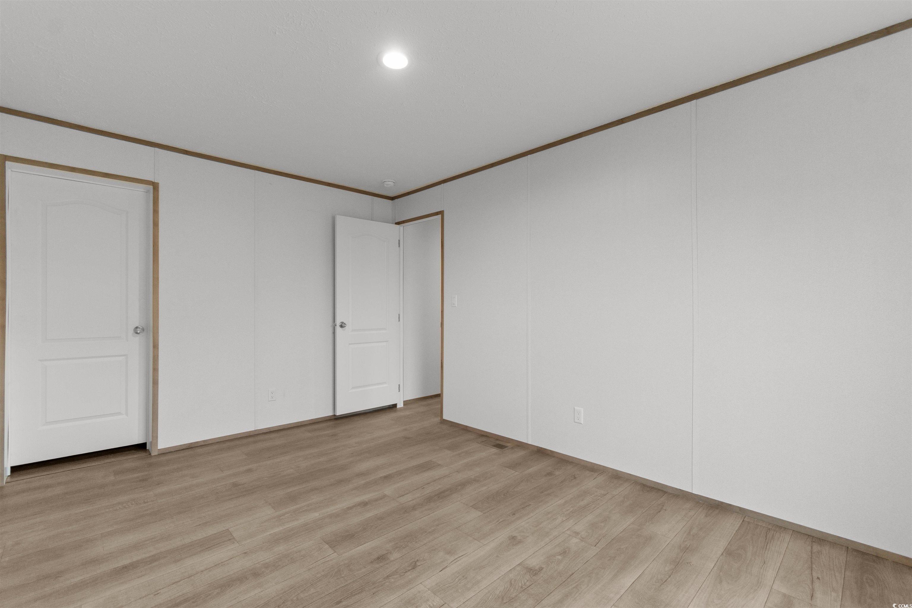 6613 Strickland Road Green Sea, SC 29545 - Photo 25 of 38 Unfurnished bedroom featuring ornamental molding, light wood-style flooring, and recessed lighting