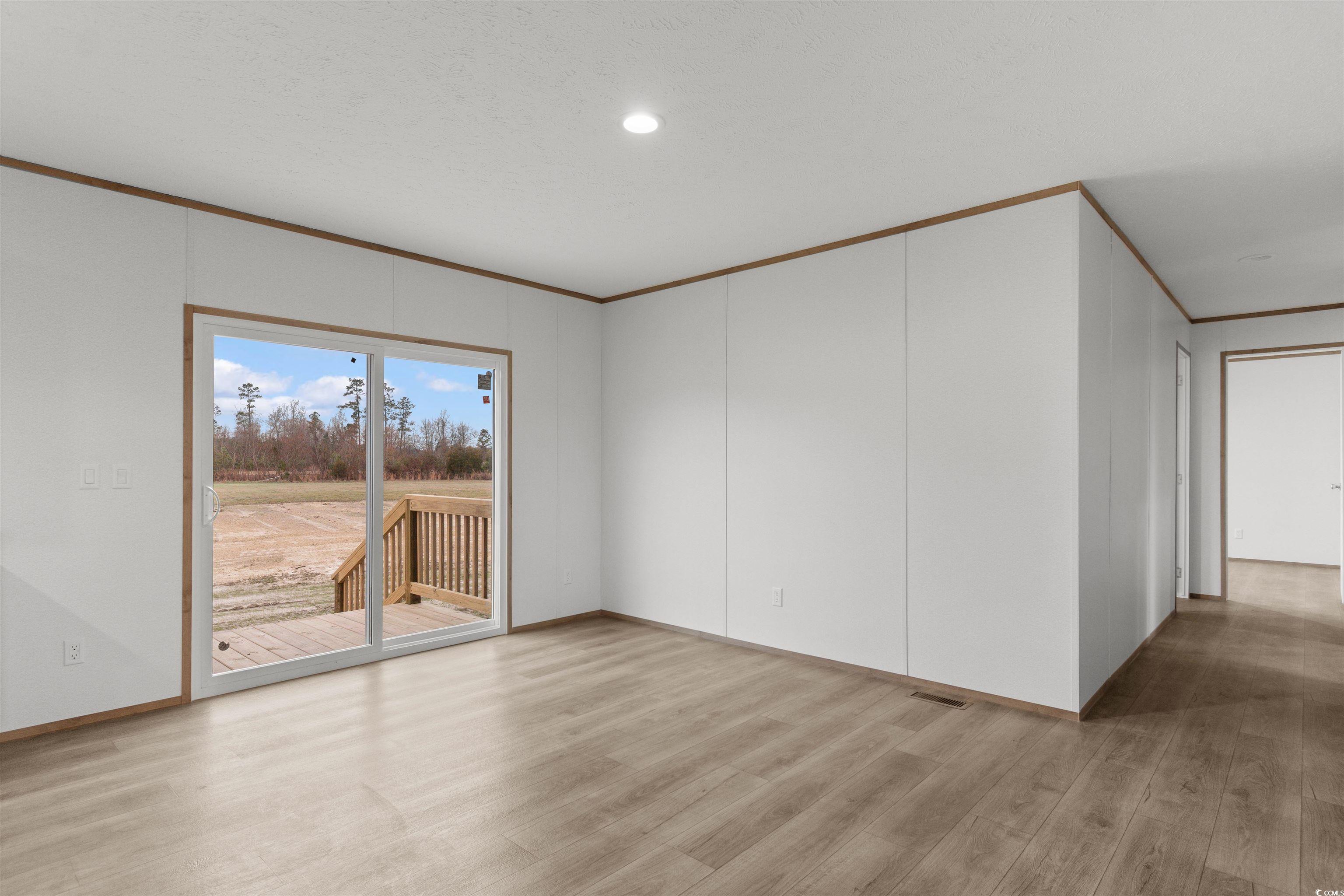 6613 Strickland Road Green Sea, SC 29545 - Photo 4 of 38 Empty room featuring ornamental molding, light wood-style floors, and recessed lighting