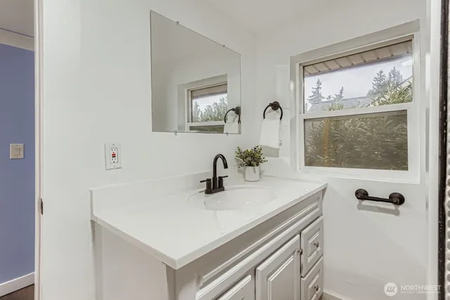 a bedroom with a large bed and a lamp