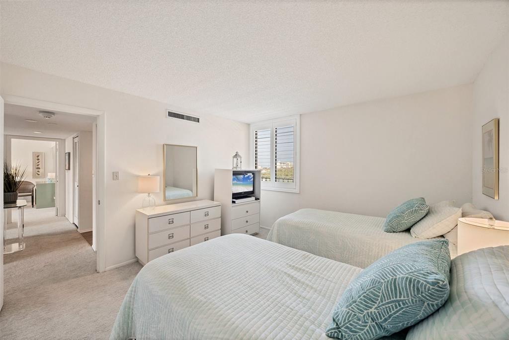 6285 Midnight Pass Road, Unit 403 Sarasota, FL 34242 - Photo 20 of 51 a bedroom with a bed and a couch