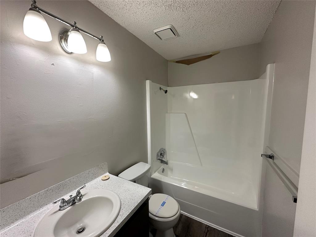 2006 Jane Street, Unit E Longview, TX 75601 - Photo 5 of 10 a bathroom with a sink toilet and shower