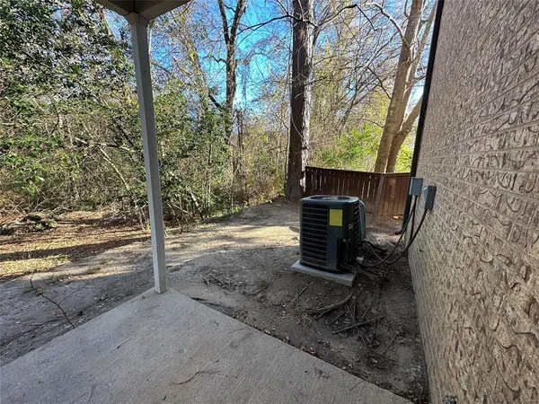 a view of a porch with wooden fence and floor