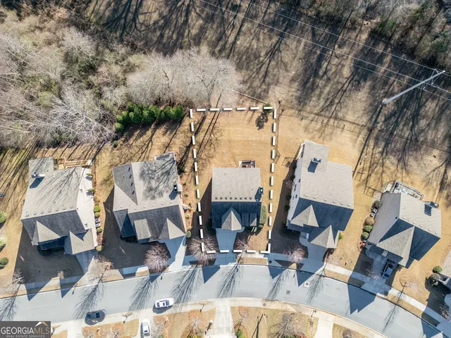 an aerial view of residential houses with outdoor space