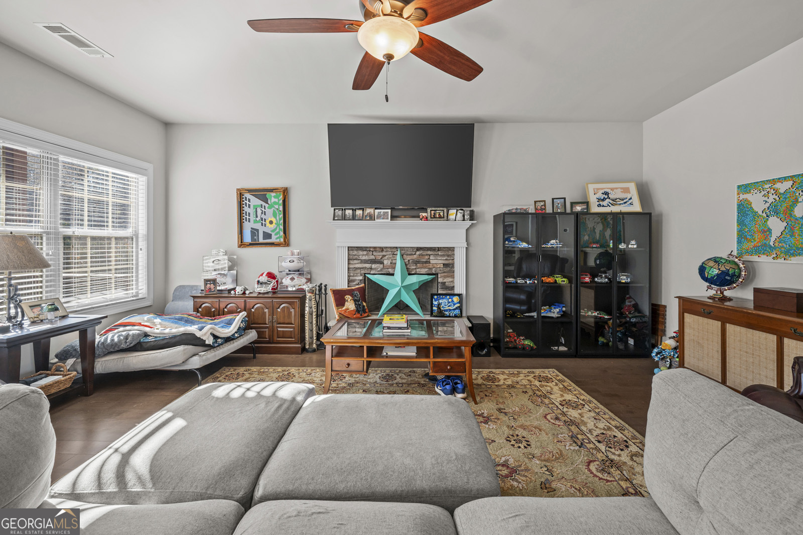 381 Township Lane Athens, GA 30606 - Photo 23 of 68 a living room with furniture a flat screen tv and a large window