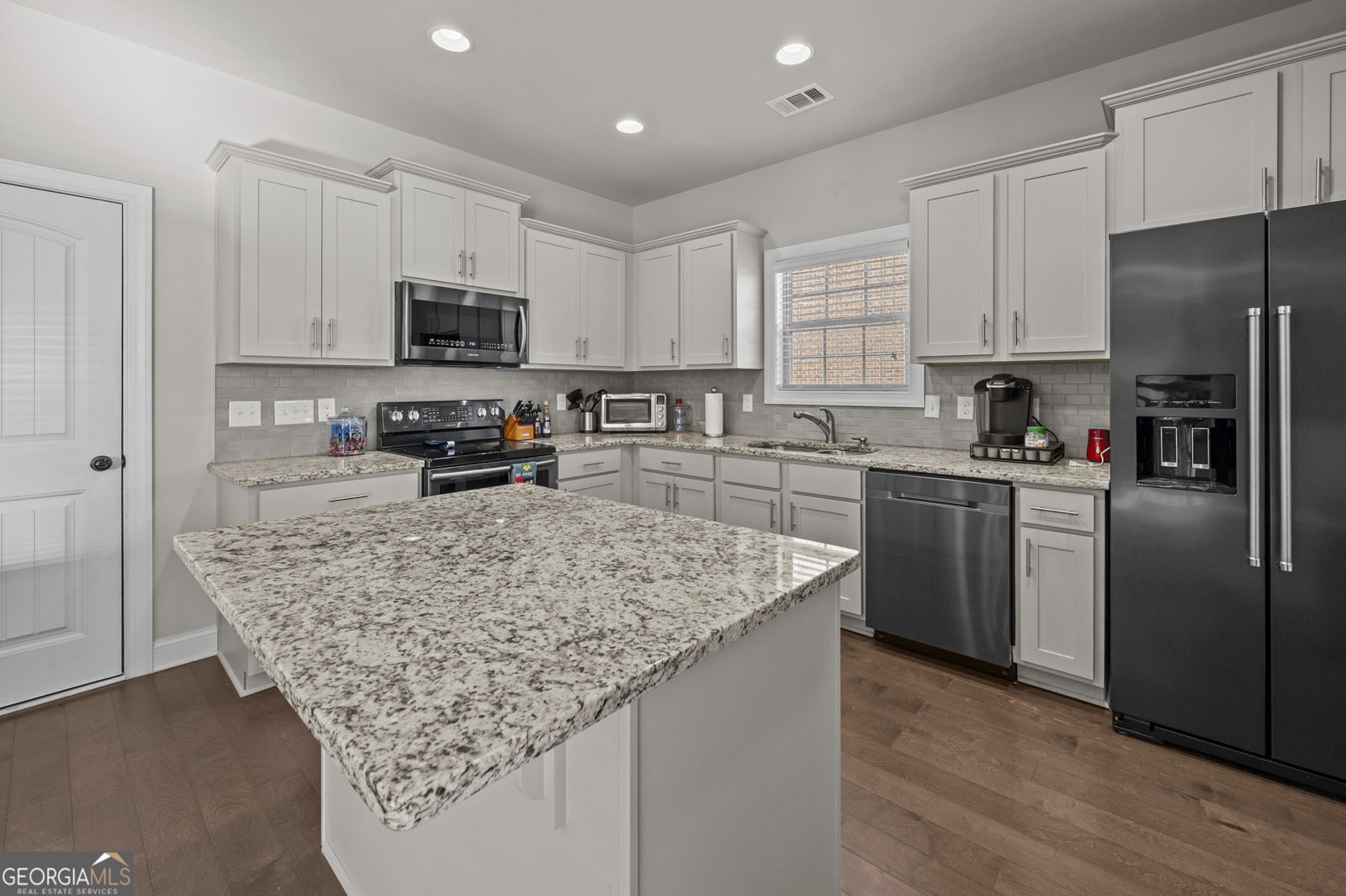 381 Township Lane Athens, GA 30606 - Photo 28 of 68 a kitchen with stainless steel appliances granite countertop a sink stove refrigerator and cabinets