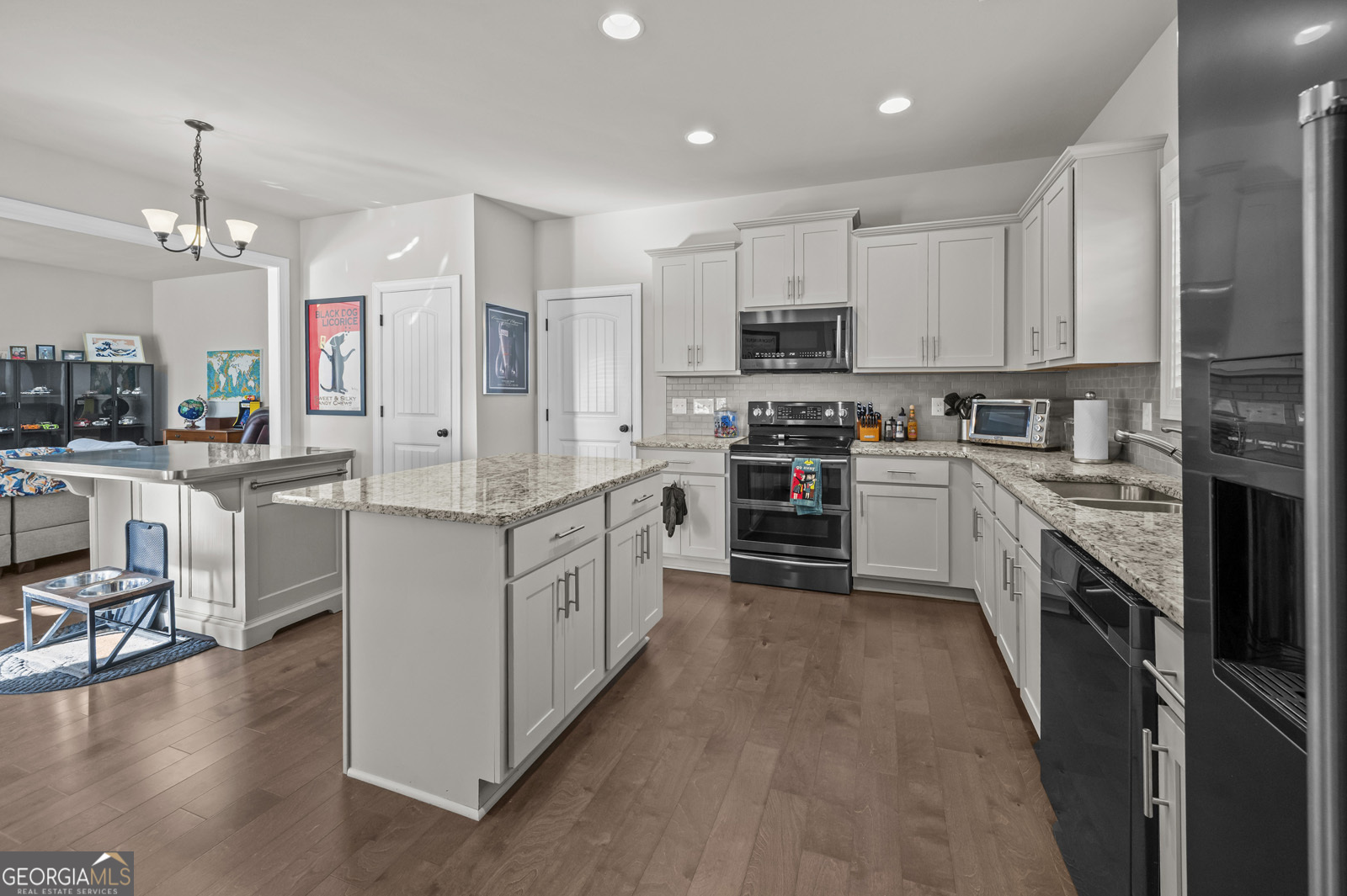 381 Township Lane Athens, GA 30606 - Photo 30 of 68 a kitchen with kitchen island granite countertop a sink a counter top space stainless steel appliances and cabinets