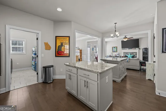 a en suite bathroom with a granite countertop sink and a mirror
