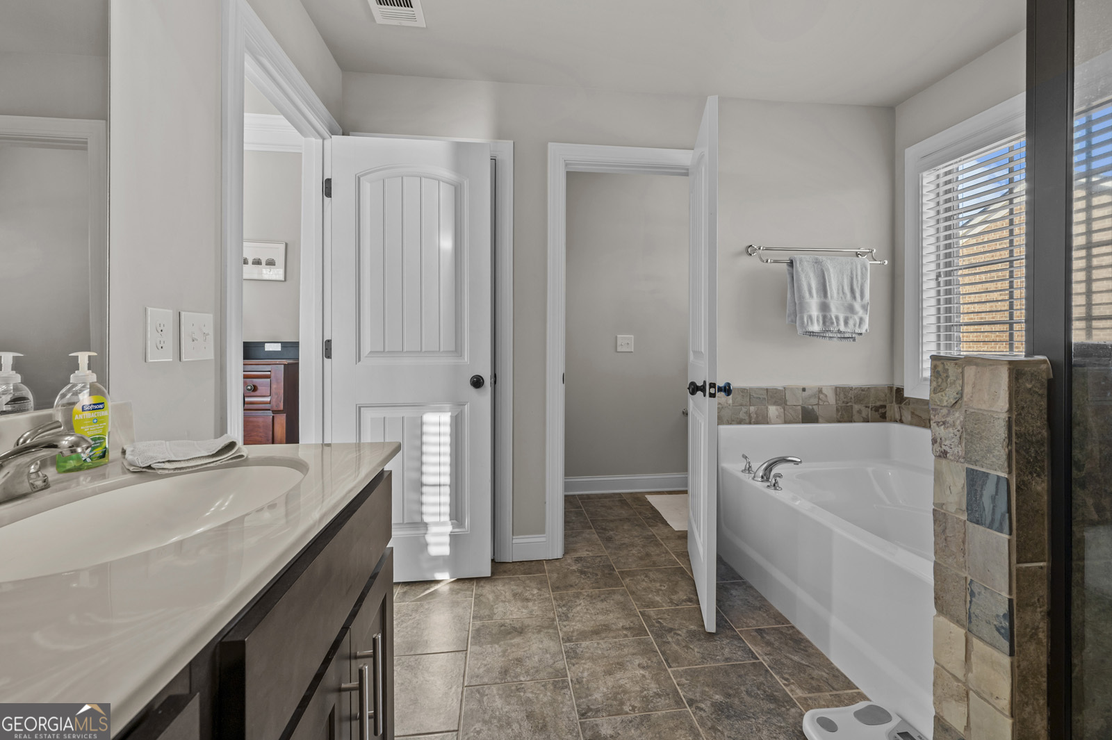 381 Township Lane Athens, GA 30606 - Photo 58 of 68 a bathroom with a granite countertop sink a toilet and shower