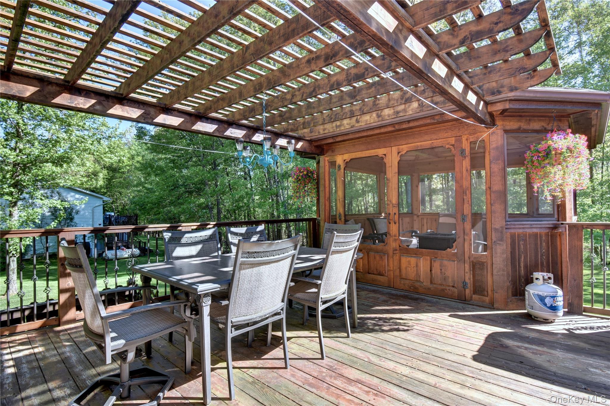 29 Valley View Road Bloomingburg, NY 12721 - Photo 34 of 50 a view of a patio with table and chairs with wooden floor and fence