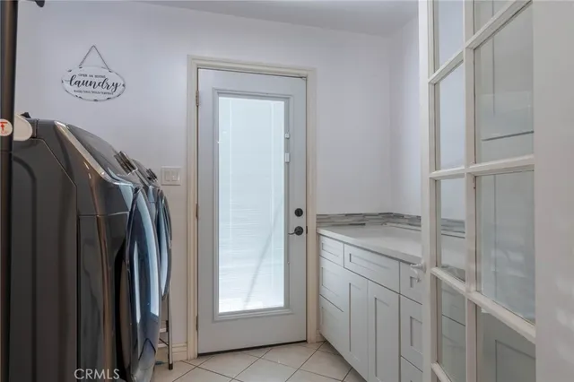 a kitchen with a refrigerator sink and cabinets
