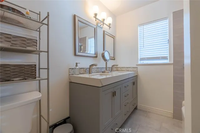 a bathroom with a sink a toilet and mirror