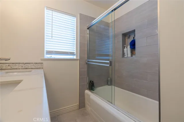 a bathroom with a tub a sink and a window