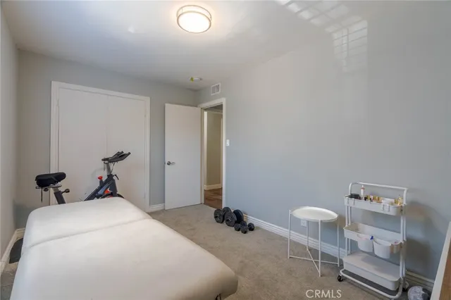 a bedroom with a bed and a chair