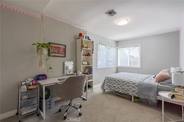 a bedroom with furniture and a window