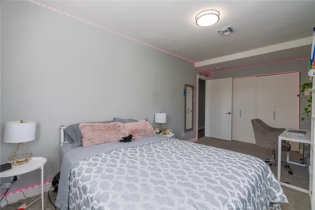 a bedroom with a bed and chair