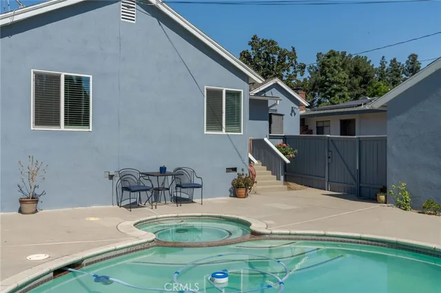 a backyard of a house with table and chairs