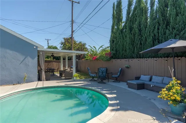 a view of a patio with chairs and plants