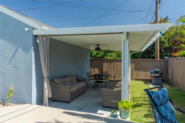 a living room with patio furniture and a garden