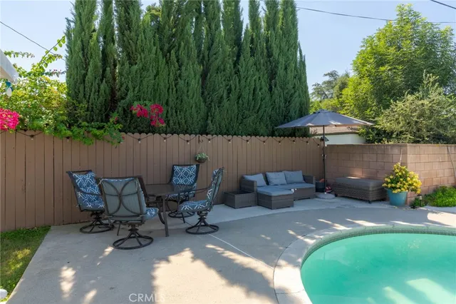 a backyard of a house with table and chairs
