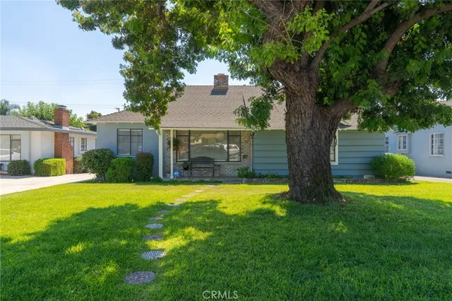 a house with swimming pool in front of it
