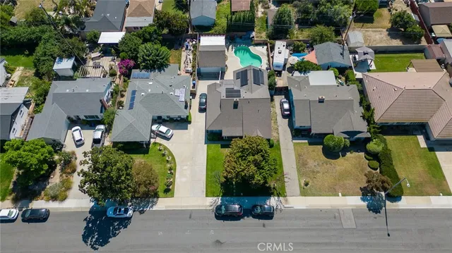 an aerial view of a house with a yard and potted plants